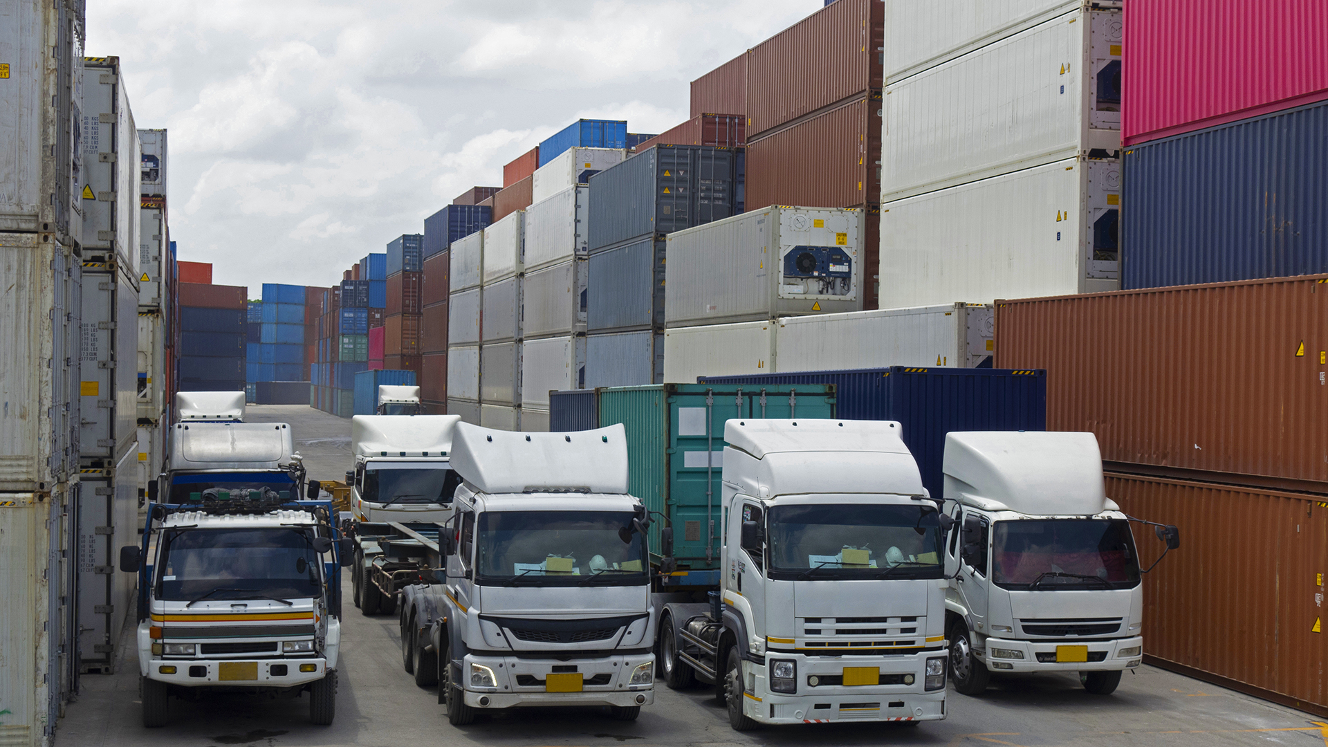 Trucks in front of containers